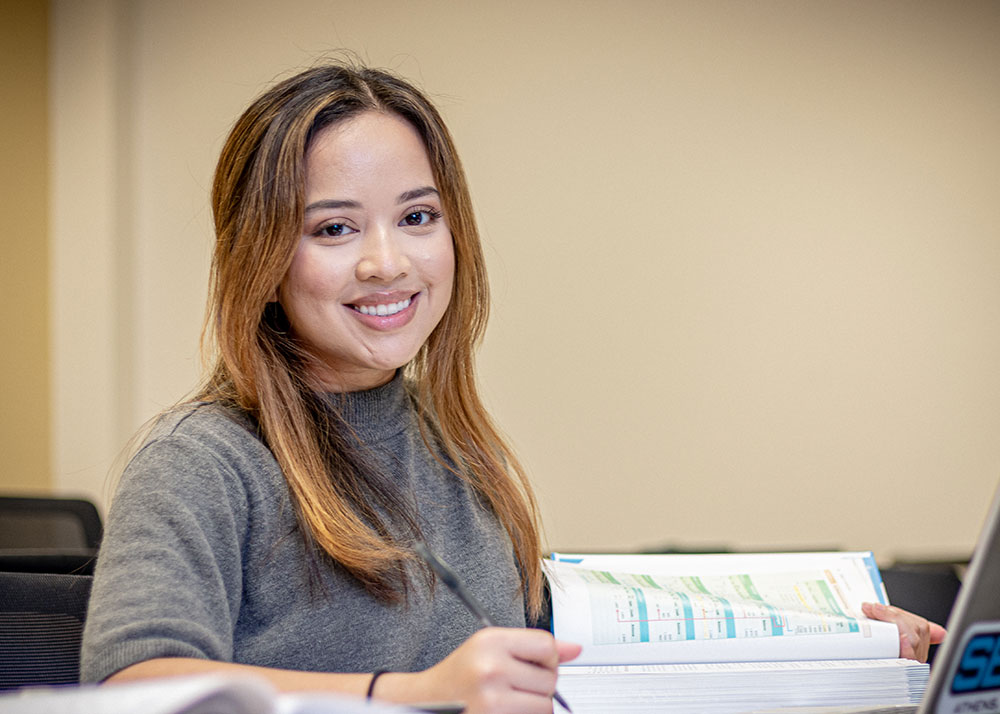 Close up of female student w/ open textbook