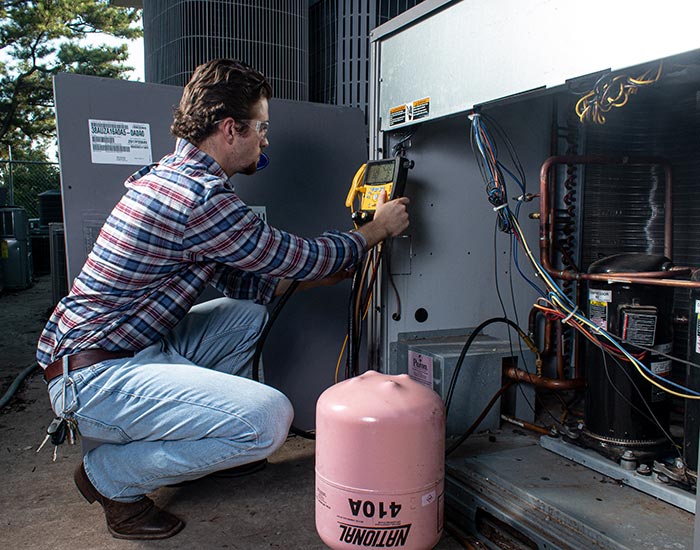 Student testing a/c unit