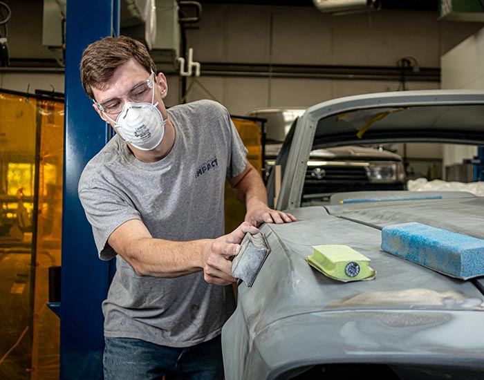 Student sanding car body