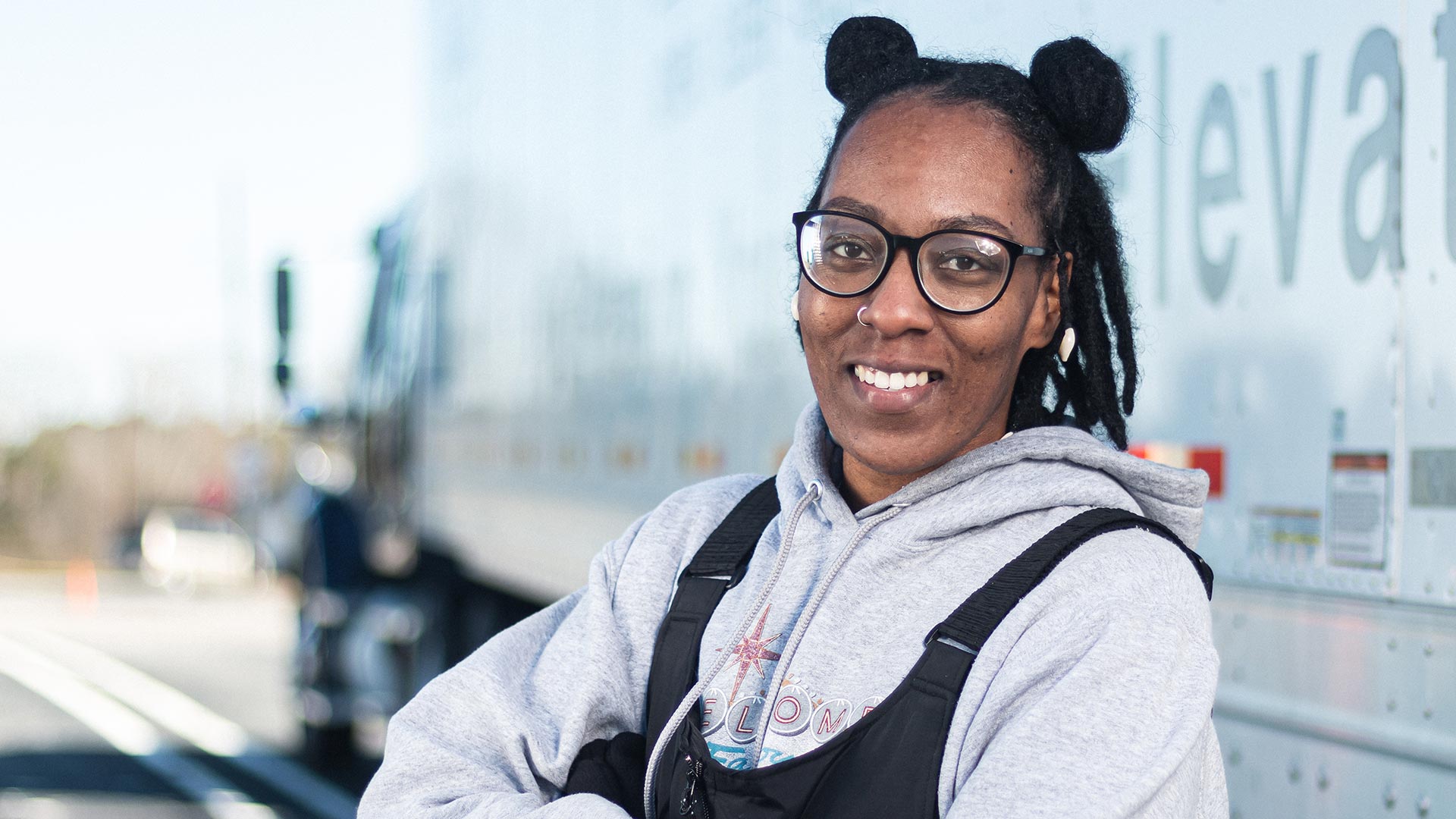 Commercial truck driving student posing outside of 18 wheeler