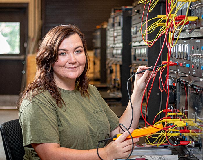 Female student working on electrical wiring