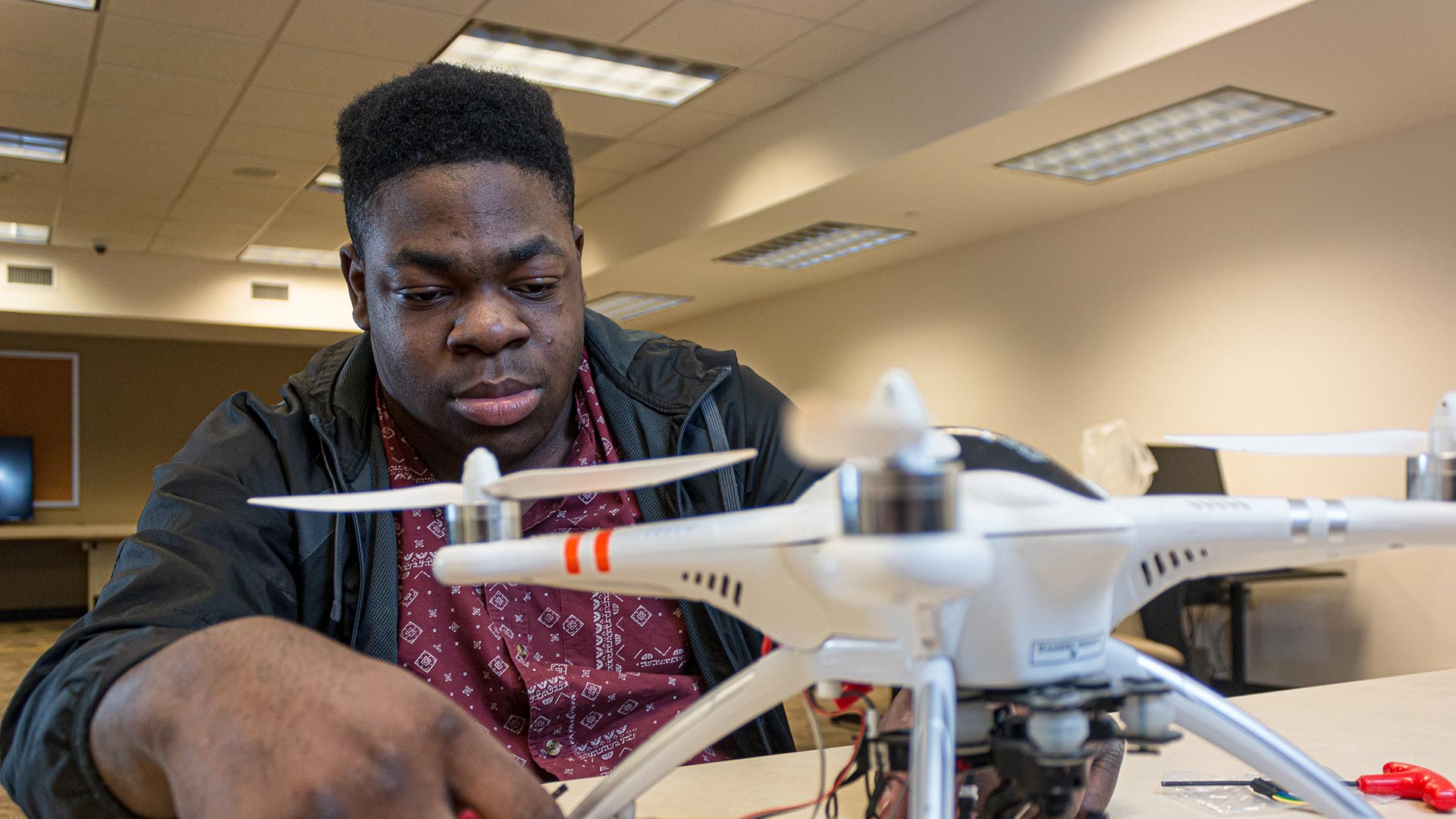 Male student working with drone - emerging tech