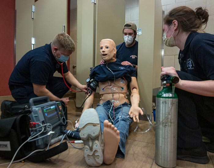 EMT students practicing on a dummy