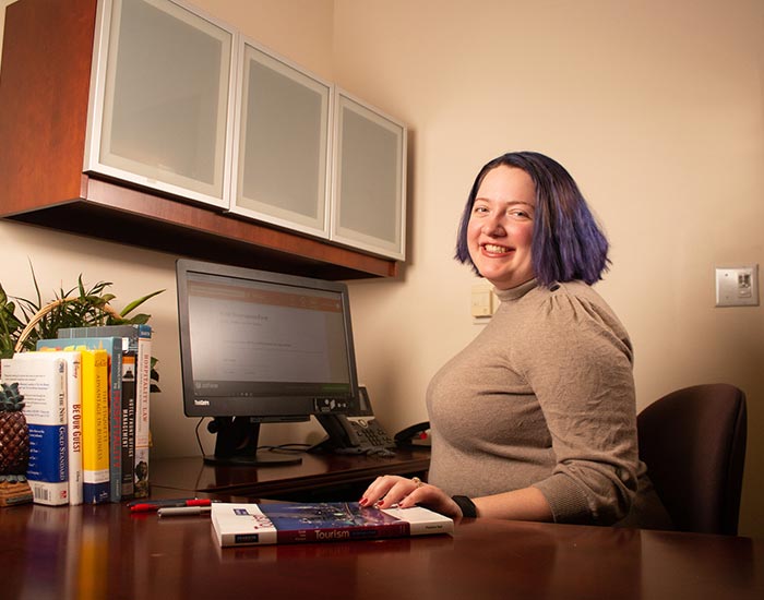 Student sitting at desk working on computer - hotel/tourism management