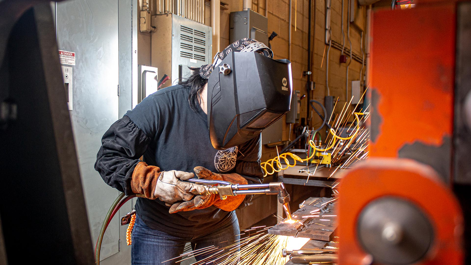 student welding w mask on